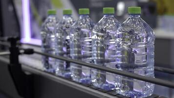 The Modern Water Bottling Process Utilizes Clear Plastic Containers for Optimal Efficiency. Media photo