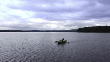 A beautiful and serene view of a tranquil lake, showcasing a dramatic sky and a small boat. Stock Clip photo
