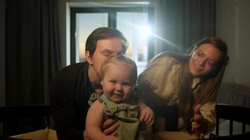 Mom and dad are playing with their little daughter in their apartment. child cannot sleep. Happy family with small child video