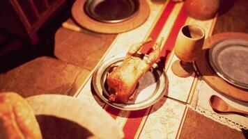 A festive dining table adorned with a roast, drinks, and various dishes video