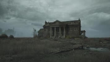 Abandoned mansion standing alone in desolate landscape under overcast sky video
