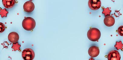 Frame from Christmas red balls on a blue background. Christmas background. New Year's banner. Copy space. photo