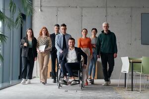 A diverse group of business professionals walking together through the office, symbolizing unity and strength as a collaborative and successful team photo