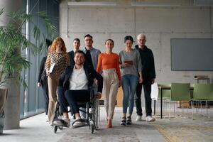 A diverse group of business professionals walking together through the office, symbolizing unity and strength as a collaborative and successful team photo