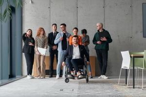 A diverse group of business professionals walking together through the office, symbolizing unity and strength as a collaborative and successful team photo