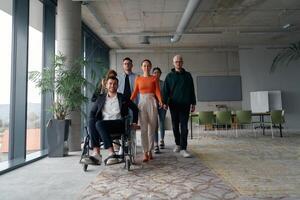 A diverse group of business professionals walking together through the office, symbolizing unity and strength as a collaborative and successful team photo