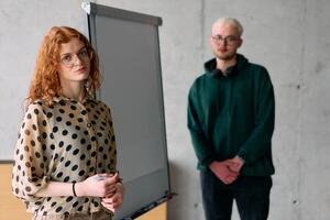 A business colleague collaboratively presenting business goals and strategies to their team in a professional office setting photo