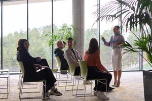 A businesswoman leader guiding a meeting with her colleagues, discussing business challenges, marketing strategies, and new plans for growth and success photo