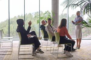 A businesswoman leader guiding a meeting with her colleagues, discussing business challenges, marketing strategies, and new plans for growth and success photo