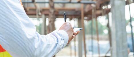 inspector or engineer is inspecting construction and quality assurance new house using a checklist. Engineers or architects or contactor work to build the house before handing it over to the homeowner photo