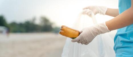 Save water. Volunteer pick up trash garbage at the beach and plastic bottles are difficult decompose prevent harm aquatic life. Earth, Environment, Greening planet, reduce global warming, Save world photo