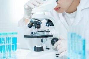 Scientist analyze biochemical samples in advanced scientific laboratory. Medical professional use microscope look microbiological developmental of viral. Biotechnology research in science lab. photo
