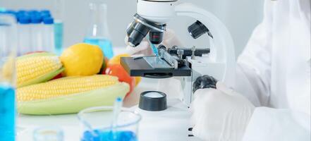 Scientist check chemical food residues in laboratory. Control experts inspect quality of fruits, vegetables. lab, hazards, ROHs, find prohibited substances, contaminate, Microscope, Microbiologist photo