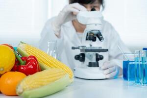 Scientist check chemical food residues in laboratory. Control experts inspect quality of fruits, vegetables. lab, hazards, ROHs, find prohibited substances, contaminate, Microscope, Microbiologist photo