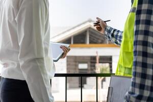 inspector engineer and owner project is inspecting construction and quality assurance new house. Engineers or architects or contactor work to build the house before handing it over to the homeowner photo