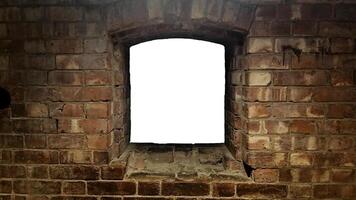 An empty window in a brick wall photo