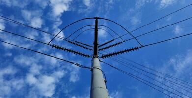 A high voltage power line with wires and clouds photo