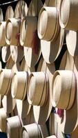 Many hats are hanging on a rack photo