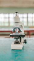 Microscope on a table in a laboratory with natural light from windows. photo