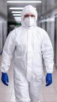 Person in protective suit walking in a laboratory corridor. photo