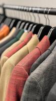 Tailored jackets on a display rack, colorful collection, white isolate background photo