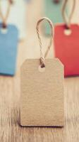 Blank brown tag with twine on wooden surface, ideal for labeling or decoration. photo