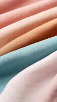 Close-up view of soft, colorful fabric folds showcasing diverse textures and shades. photo