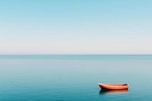 A tranquil scene featuring a solitary orange boat on calm blue waters. photo