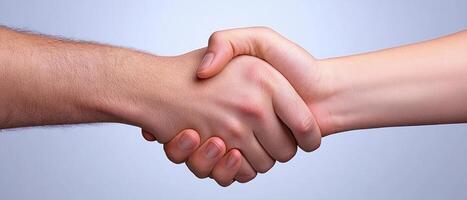 A close-up of two hands shaking, representing partnership and agreement. photo
