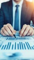 Professional hands analyzing financial graphs for business success and growth strategy. photo