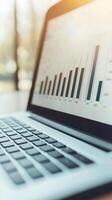 Close-up view of a laptop displaying financial growth graph and data analysis. photo