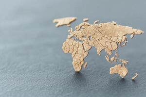 Detailed wooden world map on a textured surface, showcasing global geography. photo