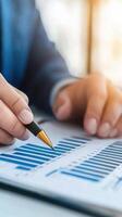 A businessman analyzing financial data on a chart with focus and precision. photo