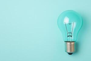A stylish light bulb against a teal background, symbolizing creativity and innovation. photo
