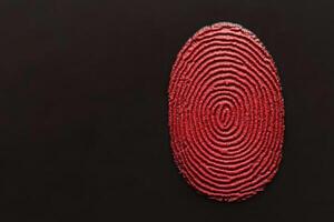 An artistic representation of a red fingerprint on a black background. photo