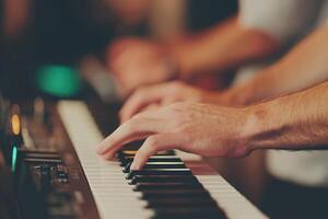 Close-up of hands playing a keyboard, creating beautiful music in a lively environment. photo