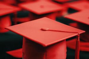 Red graduation caps arranged in a row, symbolizing achievement and educational success. photo