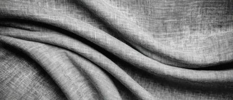 Textured gray fabric draping elegantly in soft waves and folds, showcasing subtle patterns. photo