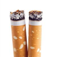 Two cigarettes with glowing tips on a white background. isolated on white background. photo