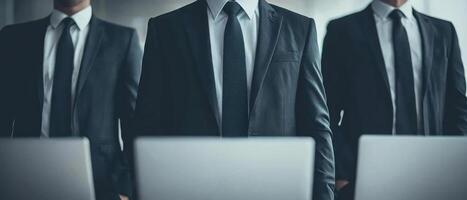 Three professionals in suits collaborating in a modern office setting. photo
