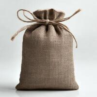 A rustic burlap bag tied with twine, perfect for packaging, storage, or decorative purposes in a minimalist setting. photo