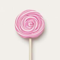 Delicious pink swirl lollipop on a stick against a plain background. isolated on white background. photo