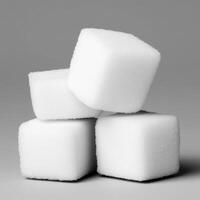 Four sugar cubes stacked neatly on a plain background. isolated on white background. photo