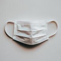A close-up of a white surgical mask on a plain background. isolated on white background. photo