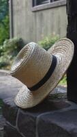 A straw hat is sitting on a stone wall photo