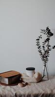 A table with a vase, a bowl and a spoon photo