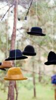 A group of hats hanging from strings photo