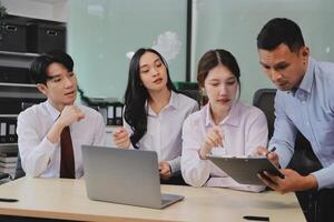 Entrepreneurs and business people conference in modern meeting room, happy multiracial coworkers have fun cooperating working together at office meeting, asian teamwork concept photo
