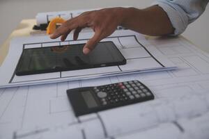 Image of engineer meeting for architectural project. working with partner and engineering tools on workplace vintage tone. photo