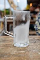 Empty beer mug covered with frost photo